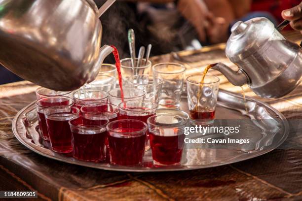 serving hibiscus tea in a nubian home in egypt - cranberry juice stock pictures, royalty-free photos & images