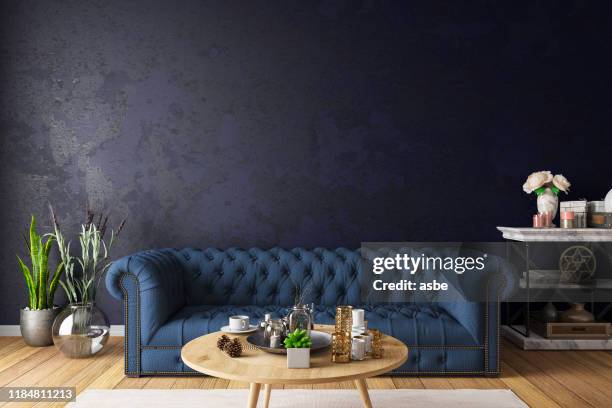 chesterfield sofa with dark wall - chesterfield sofa stock pictures, royalty-free photos & images