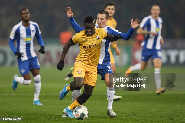 Vladimir Darida of Hertha Berlin and Moussa Kone of Dresden battle for possession during the DFB Cup second round match between Hertha BSC and Dynamo...