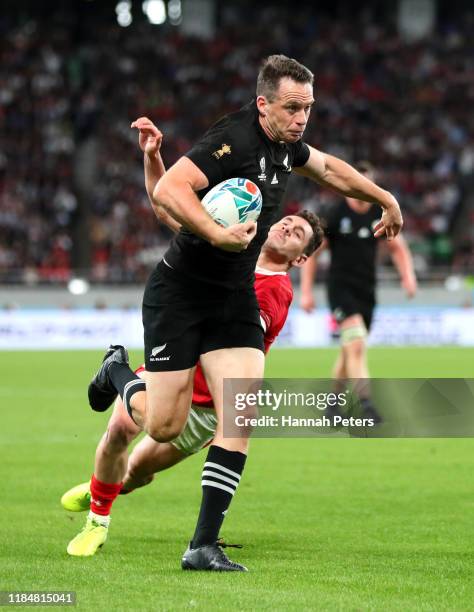Ben Smith of New Zealand hands off Tomos Williams of Wales as he scores his team's fourth try during the Rugby World Cup 2019 Bronze Final match...