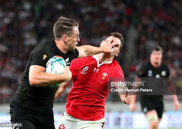 Ben Smith of New Zealand hands off Tomos Williams of Wales as he scores his team's fourth try during the Rugby World Cup 2019 Bronze Final match...