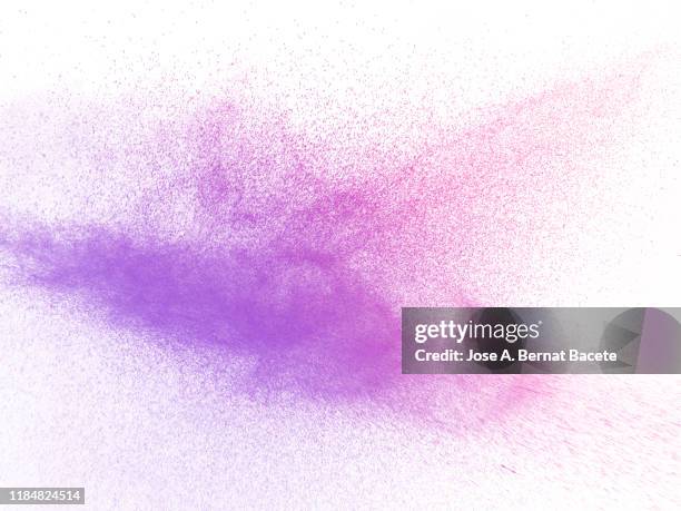 full frame of the textures formed by the water jets to pressure with drops floating in the air of multi colored on a white background. - color explosion water stock-fotos und bilder