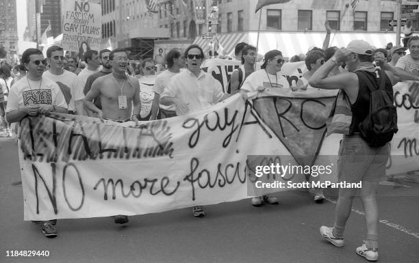 Gay rights activists from Italy carry a banner that reads 'Italia Gay ARC, No More Fascism' as they march down Central Park South during the Gay...