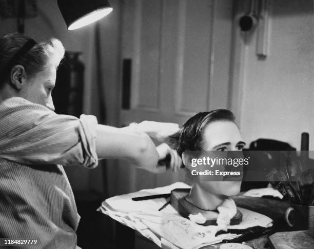 The waxwork head of Antony Armstrong-Jones, Lord Snowdon, is given a wash and shampoo at Madame Tussauds in London, England, having been stolen and...