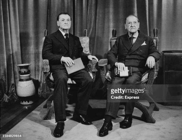 English writer W. Somerset Maugham approves his waxwork at Madame Tussauds in London, England, 15th November 1962. The real Maugham is holding a copy...