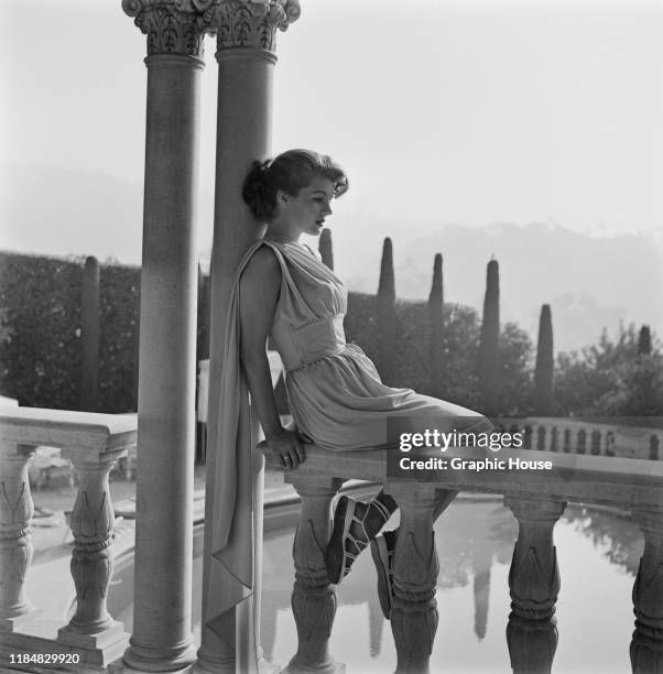 French actress Corinne Calvet wearing Italian fashions inspired by ancient Rome in Rome, Italy, circa 1950.