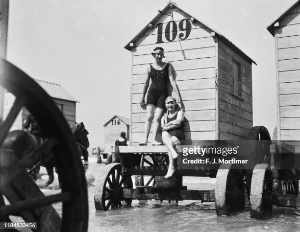 Bathers and bathing machines at Ostend, Belgium, circa 1900.