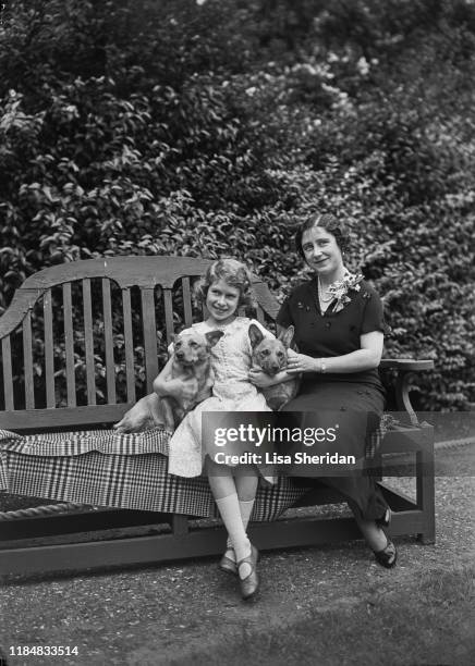 The Royal Princess Elizabeth with her mother, Elizabeth Bowes-Lyon , and their Pembroke Welsh Corgi dogs, Dookie and Jane, at her home at 145...