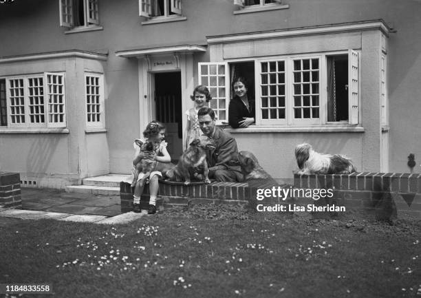 The Royal Princesses Margaret and Elizabeth with their mother, Elizabeth Bowes-Lyon and their father Albert, Duke of York with their dogs, including...