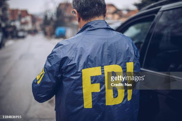 the back of an fbi agent - fbi stock pictures, royalty-free photos & images