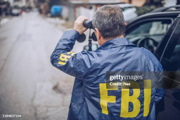 一個老fbi探員用望遠鏡觀察 - fbi 個照片及圖片檔