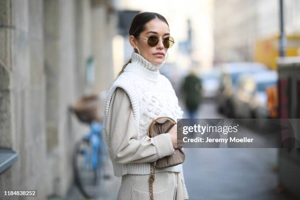 Anna Schürrle wearing Cult Gaia earrings, Isabel Marant Etoile shirt, Isabel Marant vest, Nanushka skirt, Gianvito Rossi heels, Max Mara bag and...