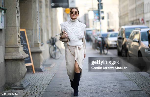 Anna Schürrle wearing Cult Gaia earrings, Isabel Marant Etoile shirt, Isabel Marant vest, Nanushka skirt, Gianvito Rossi heels, Max Mara bag and...