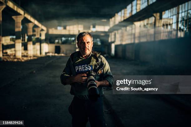 war reporter with camera in war zone - conflict zone stock pictures, royalty-free photos & images