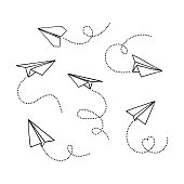 VVector set of hand drawn doodle paper airplane isolated on white background. Line icon symbol of travel and route.