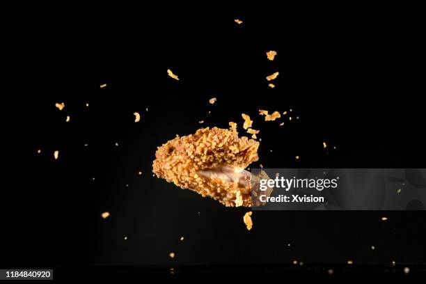 crispy chicken meat flying in mid air captured with high speed sync."n - empanada fotografías e imágenes de stock