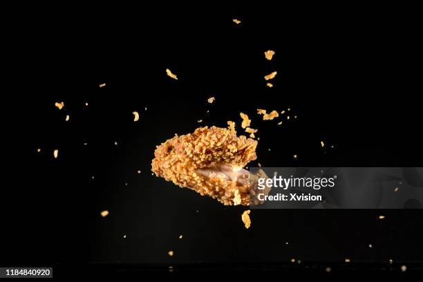 crispy chicken meat flying in mid air captured with high speed sync."n - crunchy food stock pictures, royalty-free photos & images