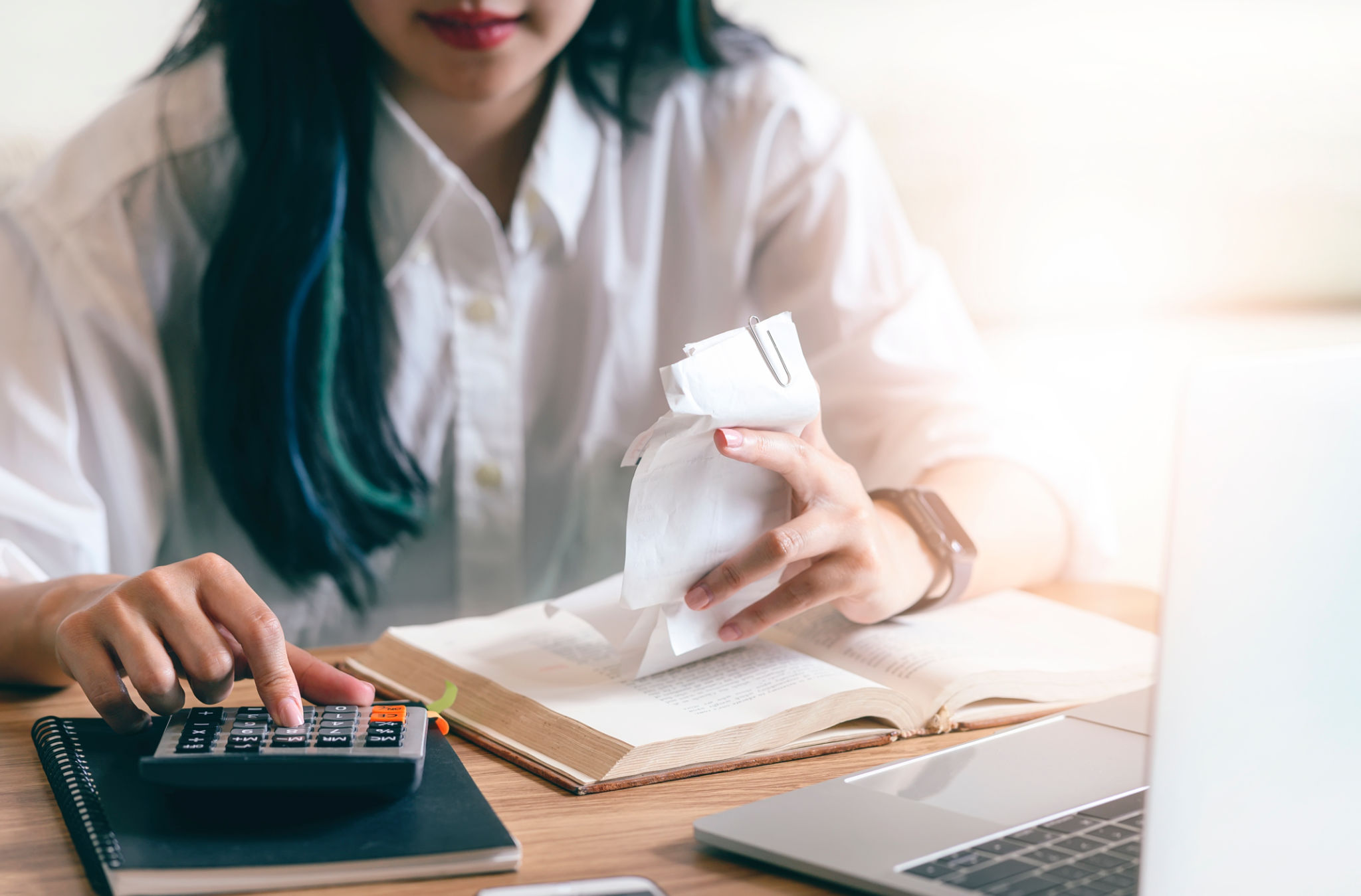 Closeup young woman calculating accounting budget with calculator. Closeup young woman calculating accounting budget with calculator.