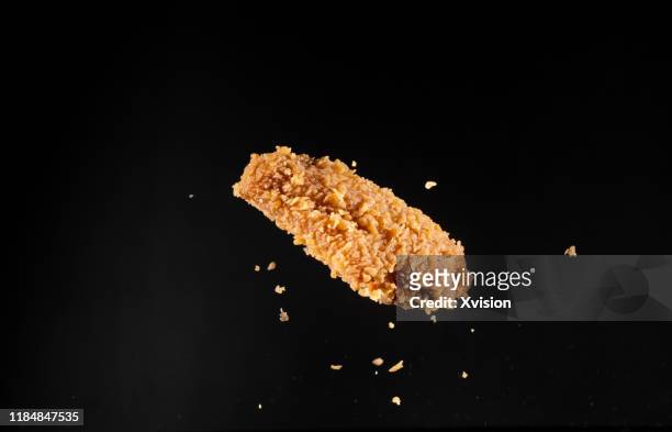 crispy chicken wings flying in mid air captured with high speed sync."n - chicken wings stock pictures, royalty-free photos & images