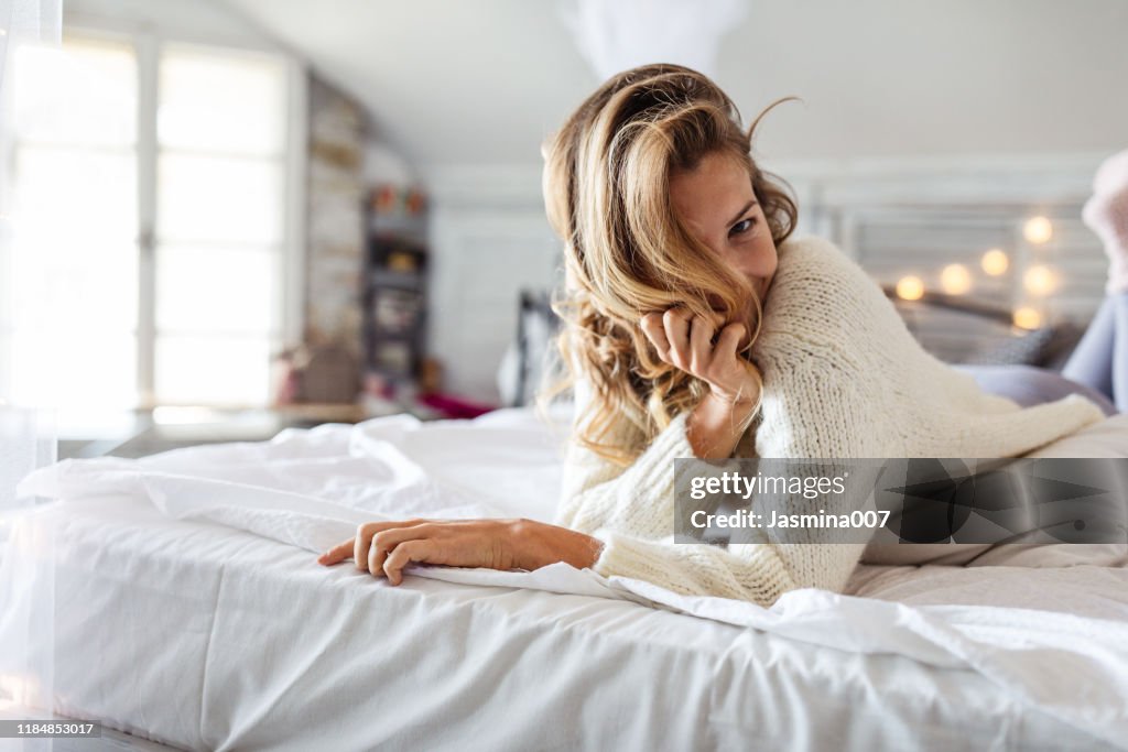 Laughing woman covering her eyes with her hair