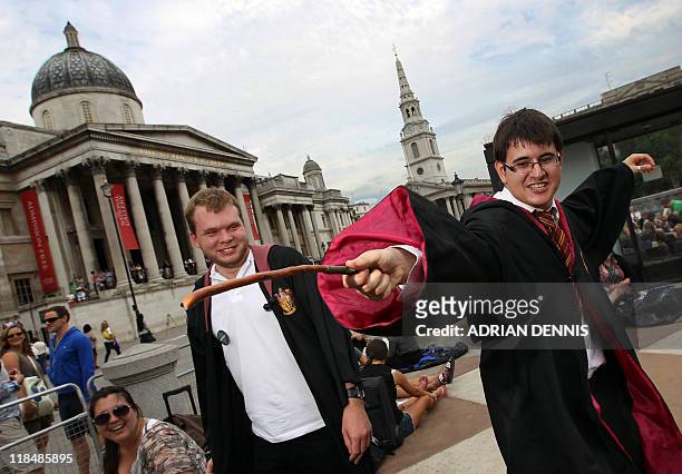 Alex Moustakakis strikes a pose with his wand alongside his friend Aaron Lewis while being photographed in the queue for the film premiere of 'Harry...
