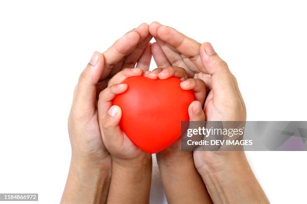 child and parent holding red heart shape - herz ekg hand stock-fotos und bilder