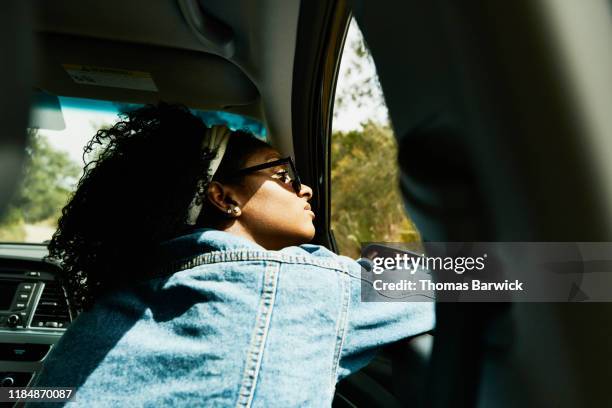 woman looking out open window of car driving down road - eureka california stock pictures, royalty-free photos & images