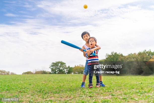 two children playing baseball - japanese baseball players strike stock pictures, royalty-free photos & images