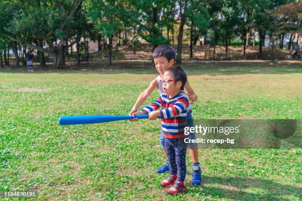 two children playing baseball - japanese baseball players strike stock pictures, royalty-free photos & images