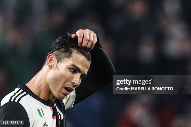 Juventus' Portuguese forward Cristiano Ronaldo takes off his hair hoop at the end of the UEFA Champions League Group D football match Juventus Turin...