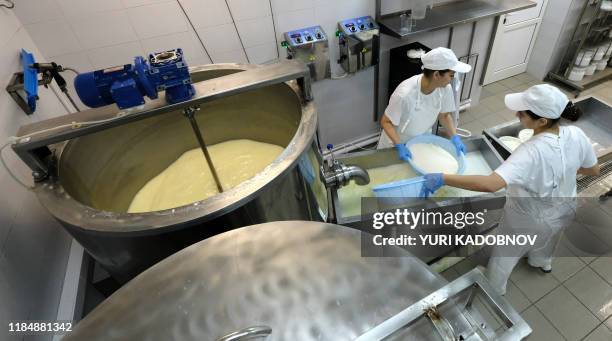 "Cheese & Beer" creamery co-owner Elvira Kovtun and her assistant Liza produce cheeses at their creamery in the industrial town of Korolyov on...