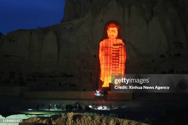 Nov. 26, 2019 -- Photo taken on Nov. 25, 2019 shows the projection of the Bamyan Buddha in orange color to commemorate the International Day for the...