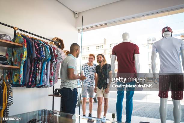 customers entering the clothing store - entering shop stock pictures, royalty-free photos & images