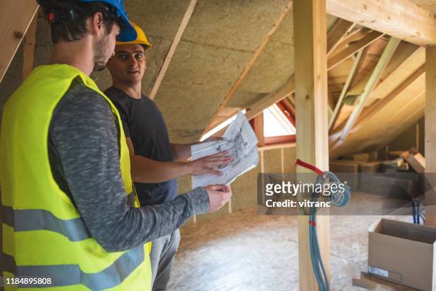 discussing on blueprint - house insulation not posing stock pictures, royalty-free photos & images