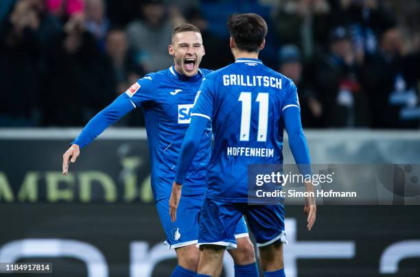 Pavel Kaderabek of Hoffenheim celebrates his team's second goal with team mate Florian Grillitsch during the Bundesliga match between TSG 1899...