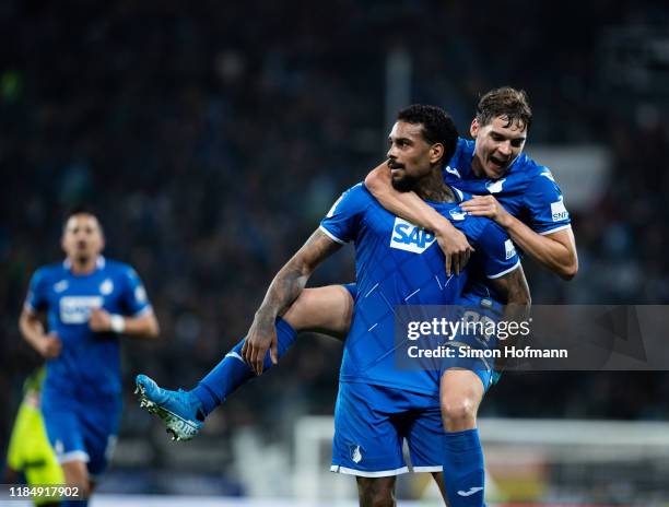 Juergen Locadia of Hoffenheim celebrates his team's third goal with team mate Robert Skov during the Bundesliga match between TSG 1899 Hoffenheim and...