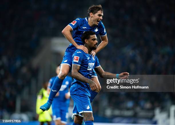 Juergen Locadia of Hoffenheim celebrates his team's third goal with team mate Robert Skov during the Bundesliga match between TSG 1899 Hoffenheim and...