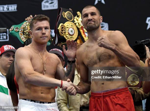 Boxer Canelo Alvarez and WBO light heavyweight champion Sergey Kovalev shake hands as they pose during their official weigh-in at MGM Grand Garden...