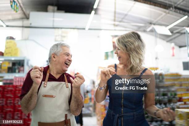 customer and employee dancing at wholesale - dancing funny carefree woman stock pictures, royalty-free photos & images