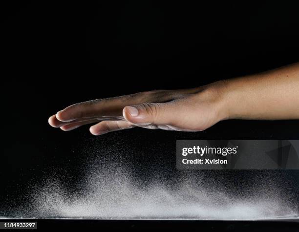 hand gesture with flying flour captured with high speed sync. - bounce back stock-fotos und bilder