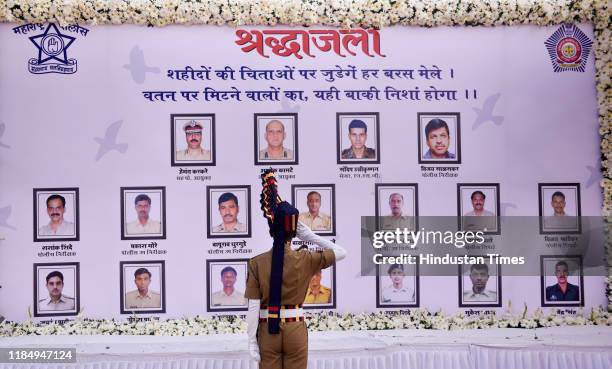 Police personnel salutes the martyrs of the 26/11 Mumbai terror attack at the Police Memorial site, on November 26, 2019 in Mumbai, India.