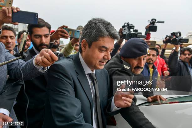 Recently resigned Pakistan's law and justice minister Mohammad Farogh Naseem leaves the Supreme Court building after a case hearing suspending the...