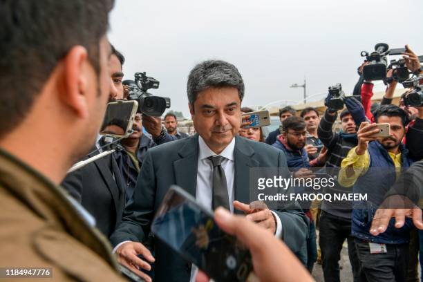 Recently resigned Pakistan's law and justice minister Mohammad Farogh Naseem leaves the Supreme Court building after a case hearing suspending the...