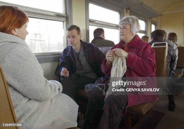 Commutors ride on a small train 11 April 2006 taking them to work on the site of reactor number four that caused the worst civil nuclear accident in...