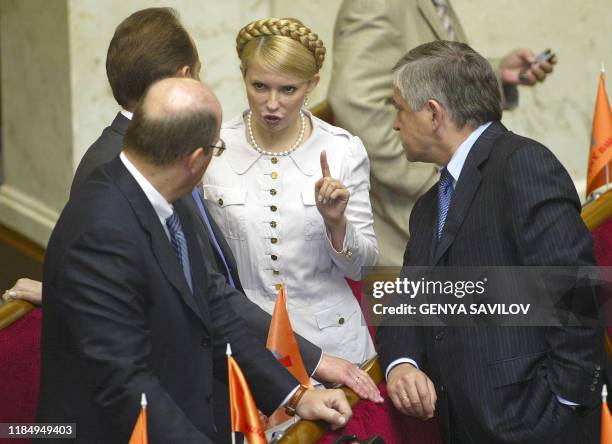 Yulia Tymoshenko , leader of parliament party Block of Yulia Tymoshenko speaks with colleagues from party Our Ukraine during parliament session in...