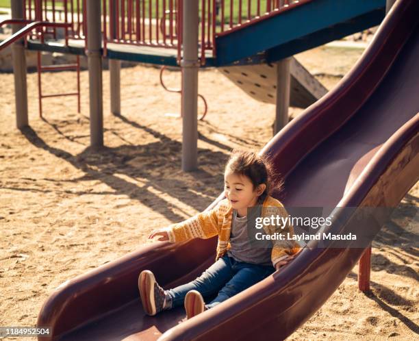 little girl on park slide age 2 - torrance stock pictures, royalty-free photos & images