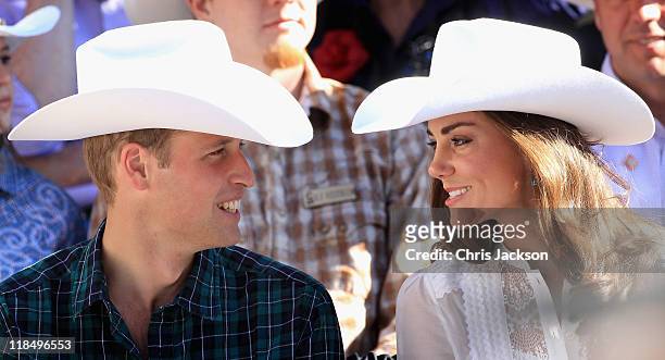 Catherine, Duchess of Cambridge and Prince William, Duke of Cambridge wave as they attend the Calgary Stampede on July 8, 2011 in Calgary, Canada....
