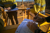 Safety supervisor checking and reviewing document before issued sigh of working at height permit