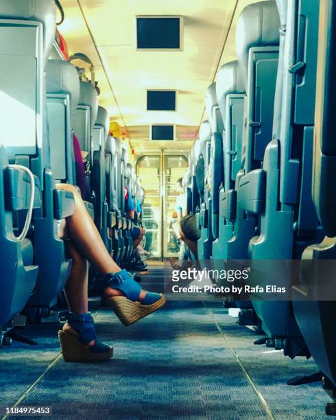 female legs in train car, fashion shoes - vagone foto e immagini stock