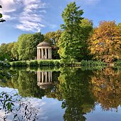 Beautiful sunny Autumn day view of Hannover Georgen public garden. Colorful trees and reflections on the water natural landscape photo